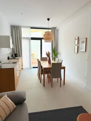 a kitchen and dining room with a table and chairs at Loft Taronja Ruzafa-Parque central in Valencia
