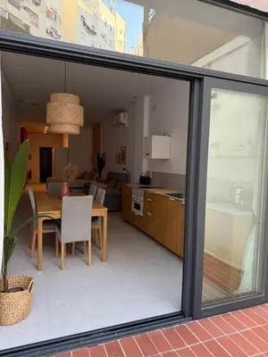 a kitchen and dining room with sliding glass doors at Loft Taronja Ruzafa-Parque central in Valencia