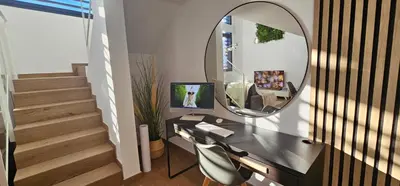 a white bedroom with a bed and a staircase at Apartamento Ciudad de Las Ciencias - Apartamento Ciudad de Les Arts in Valencia