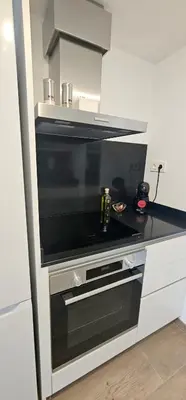 a kitchen with a microwave oven in a kitchen at Apartamento Ciudad de Las Ciencias - Apartamento Ciudad de Les Arts in Valencia