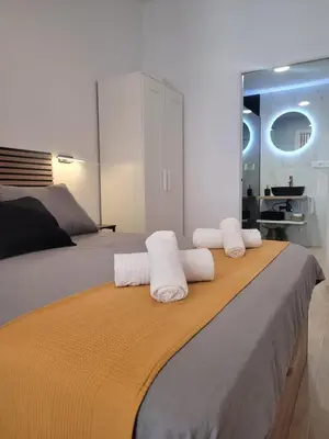 a bedroom with a bed with two towels on it at Apartamento loft con encanto Suite Home Valencia in Valencia