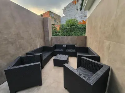 a patio with four black chairs and a window at Casa Otilia, Aventura y Relax in Buñol