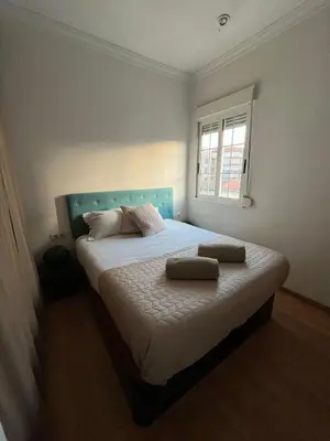 a bedroom with a bed with two pillows on it at Precioso apartamento al lado de la Ciudad de las Artes in Valencia