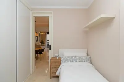 a white bedroom with a bed and a table at GuestReady - Urban retreat in Valencia in Valencia