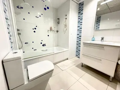 a bathroom with a toilet and a tub and a sink at Valencia Beach Home 22 in Valencia