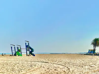 a sandy beach with a playground and palm trees at Valencia Beach Home 22 in Valencia