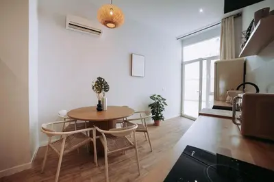 a kitchen with a table and chairs in a room at Apartamento junto a Ruzafa in Valencia