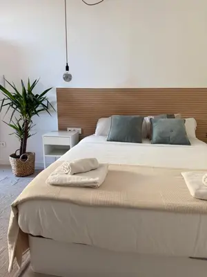 a bedroom with a large bed with two towels on it at Loft Mar Ruzafa-Parque central in Valencia