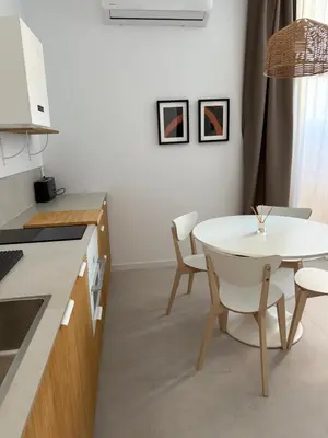 a kitchen with a table and a white table and chairs at Loft Mar Ruzafa-Parque central in Valencia