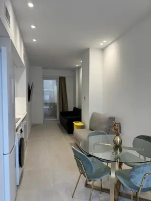 a living room with a couch and a glass table at MAGNO Loft- CIENCIAS in Valencia