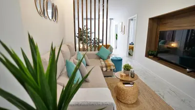 a living room with a white couch and a plant at Modern Loft in Patraix, Valencia - Near City Center in Valencia
