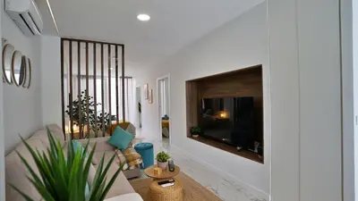 a living room with a couch and a tv at Modern Loft in Patraix, Valencia - Near City Center in Valencia