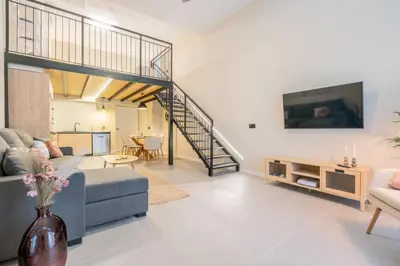 a living room with a couch and a tv at Loft HomeValencia in Valencia