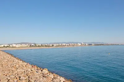 a body of water with a city in the background at Global Vacacional, Apartamento en Puerto de Sagunto in Puerto de Sagunto