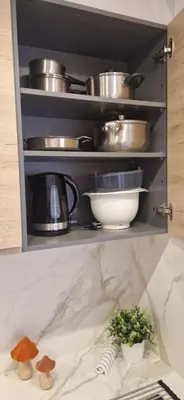 a kitchen shelf with pots and pans and a plant at Brisa Marina Stay a unos pasos del mar in Valencia