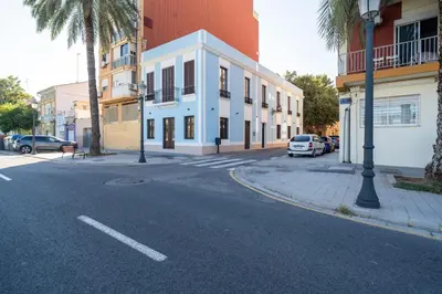 an empty street with cars parked on the side of a building at VLC HOST - Reina 168 in Valencia