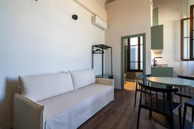 a living room with a white couch and a table at VLC HOST - Reina 168 in Valencia