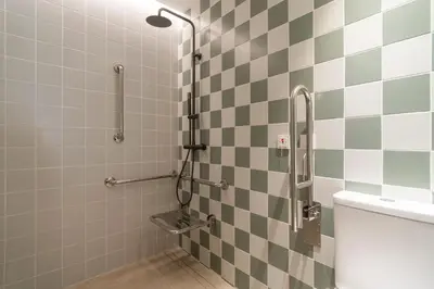a bathroom with a shower with checkerboard tiles at VLC HOST - Reina 168 in Valencia