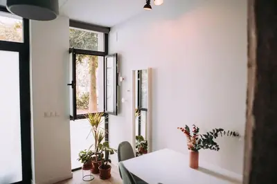 a dining room with a table and some potted plants at Parc Central Mint Apartment in Valencia