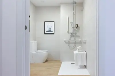 a white bathroom with a shower and a toilet at VLC HOST- B&B Fray Pedro in Valencia