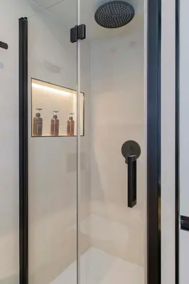 a glass shower door with jars on a shelf at Apartamento acogedor frente a Mercat Central in Valencia