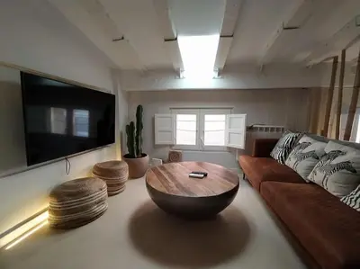 a living room with a couch and a wooden coffee table at Estudio Cama King in Valencia