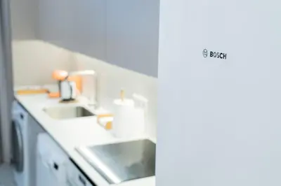 a kitchen with two sinks and a counter top at Formidable Apartments in Valencia