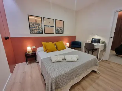 a bedroom with a bed with two pillows on it at SANCHEZ Y LASERNA STAYS Moderno Apartamento en Valencia in Valencia