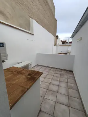 a kitchen with a counter and a tile floor at Casa Bonaire in Chella
