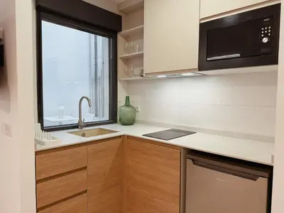 a kitchen with a sink and a microwave at Bellver Home Apartamentos in Chella