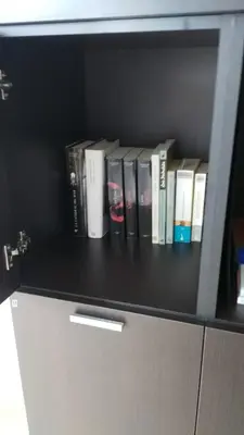 a book shelf with a bunch of books on it at Apartamento ÉLITE en Cullera playa San Antonio in Cullera