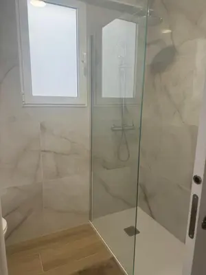 a shower with a glass door in a bathroom at Ca Maruja in Cullera