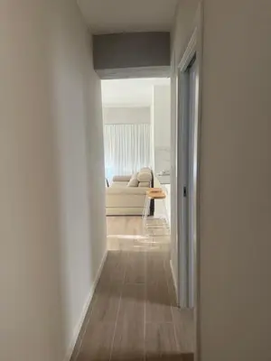 a hallway leading to a living room with a couch at Ca Maruja in Cullera