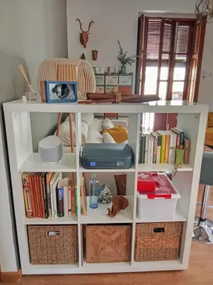 a white book shelf filled with books and baskets at Cozy flat in old town in Valencia