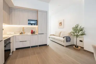 a kitchen and a living room with a couch at Suite Deluxe Valencia - Ciudad de las Artes in Valencia