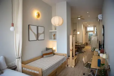 a bedroom with a bed and a living room at Apartamento con terraza Junto a Ruzafa in Valencia