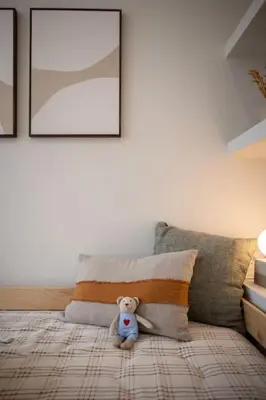 a teddy bear sitting on a bed in a room at Apartamento con terraza Junto a Ruzafa in Valencia