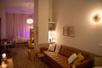a living room with a couch and a bedroom at Apartamento con terraza Junto a Ruzafa in Valencia