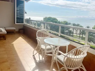 a balcony with a table and chairs and the ocean at Florazar 2 Apartamento frente al mar en Cullera in Cullera