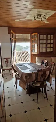 a dining room with a table and chairs in a room at Ático en el casco histórico con increibles vistas de montaña in Higueruelas