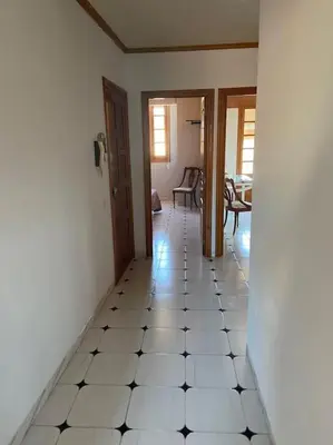 a hallway with a white tiled floor in a house at Ático en el casco histórico con increibles vistas de montaña in Higueruelas