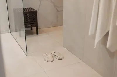 two slippers are sitting on the floor of a bathroom at SariStays Valencia Urban Chic Loft in Valencia