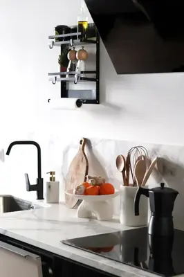a kitchen counter with a sink with a bowl of tomatoes at Stylish apartment near Old town & Turia park in Valencia