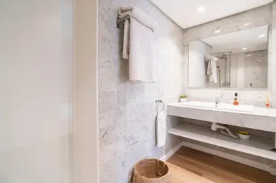 a white bathroom with a sink and a mirror at VLC HOST - Don Juan de Austria in Valencia