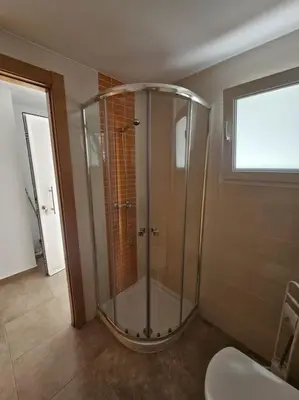 a glass shower in a bathroom with a toilet at Chalet frente al Mar in Cullera