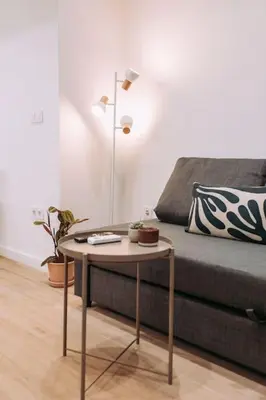 a living room with a couch and a table at Nuevo y moderno loft en amistat in Valencia