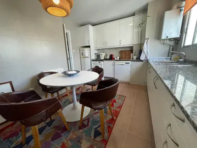 a kitchen with a table and chairs and a counter at Valencia Sky Haven in Valencia