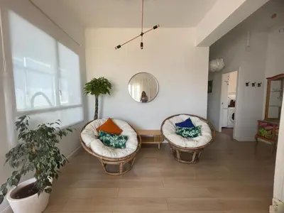 two chairs in a living room with a mirror at Valencia Sky Haven in Valencia