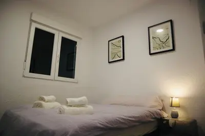 a bedroom with a bed with two towels on it at Big Flat Ruzafa in Valencia