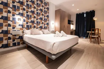 a bedroom with a large bed in a room at Yard Patraix by Concept Flats in Valencia